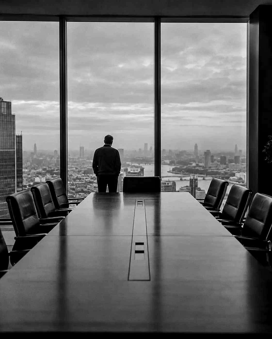 Boardroom and an executive at the window, black and white