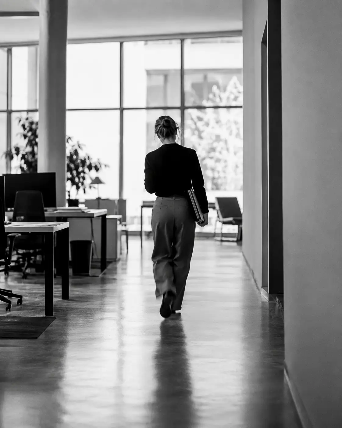 HR manager walking through an office, black and white